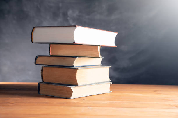 istock books on a wooden table 1361352529