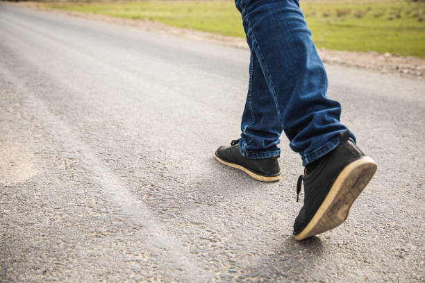 istock lonely man walks on the highway 1361352546