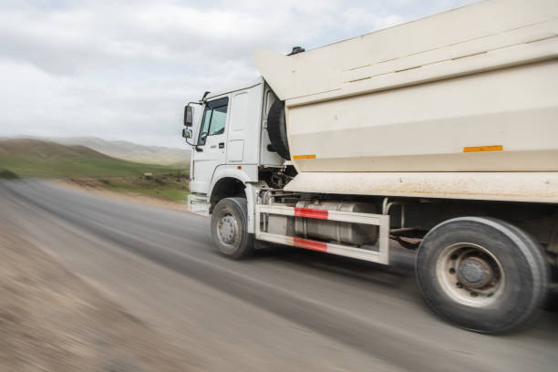 istock big white dump truck on the highway 1361352558