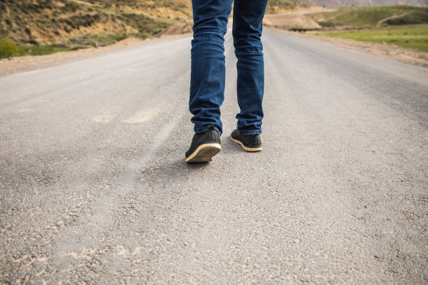 istock lonely man walks on the highway 1361352561