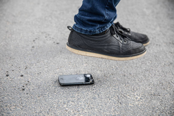 istock the man breaks the phone with his foot 1361352569