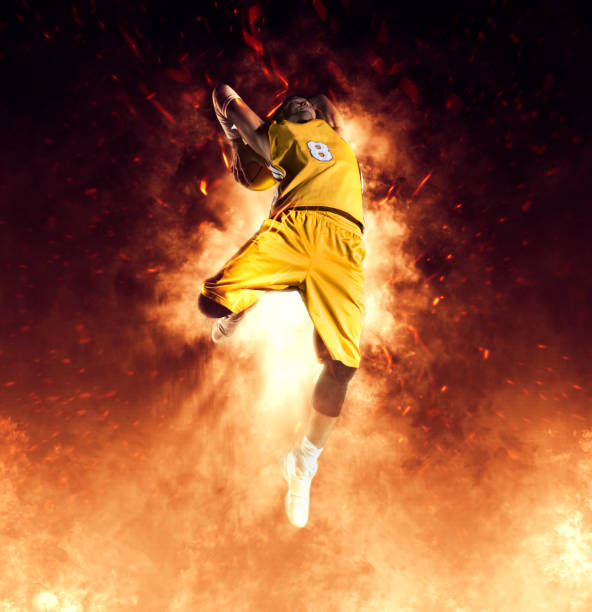 istock Man basketball player on flames background 1361354214