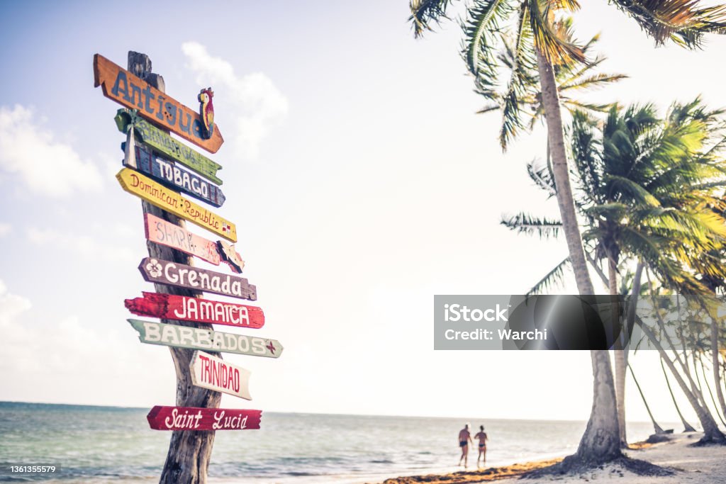Multicolored sign showing many Caribbean travel destinations Beach Stock Photo