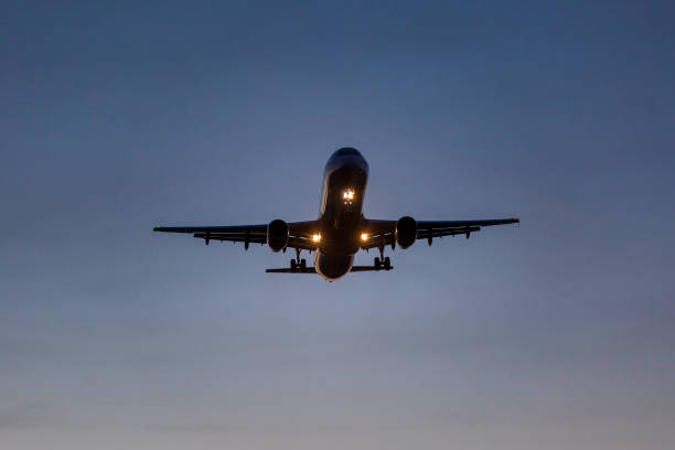 istock Landing airplane at dusk 1361355591