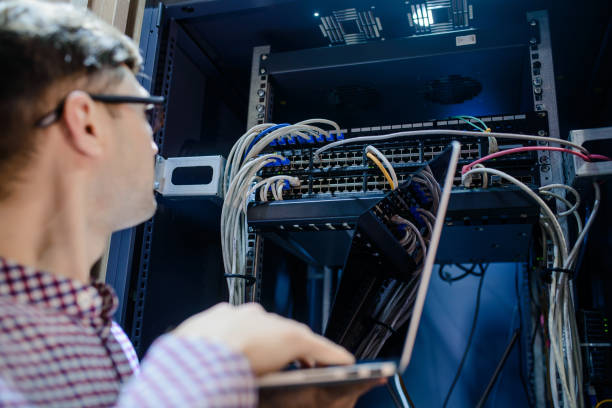 istock Photo with relfections  in the server room a technician/ It engineer/ 1361355637
