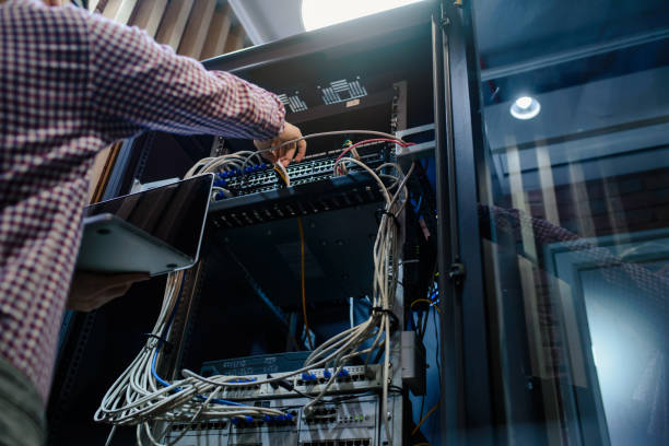 photo with relfections  in the server room a technician/ it engineer/ - computer plan fiber optic engineer imagens e fotografias de stock