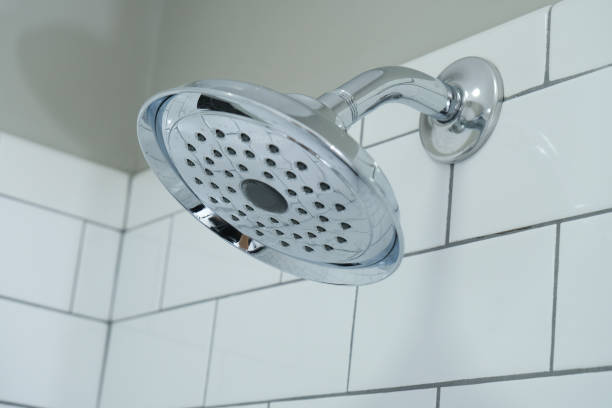 istock Chrome Shower Head in a Bathroom with White Subway Tile Walls 1361356927