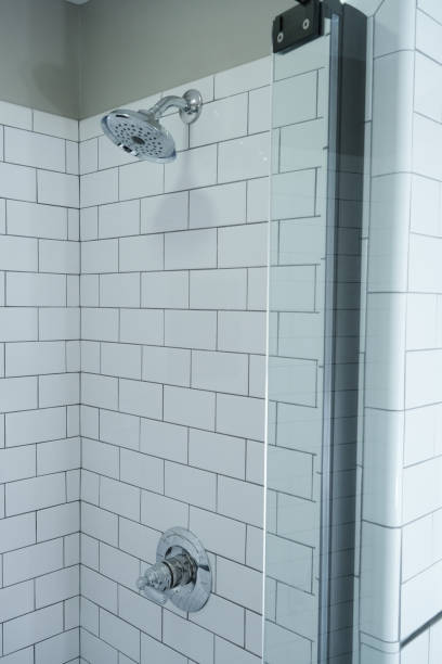 istock Chrome Shower Head and Handle in a Bathroom with White Subway Tile Walls 1361356982