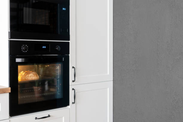 istock Process of baking food in a black oven in kitchen 1361360020