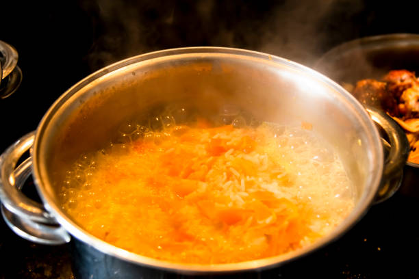 istock White brown rice cooking in the pan in a kitchen. 1361362276