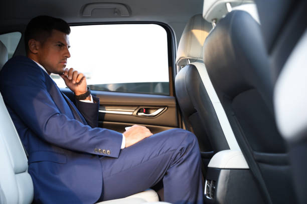 istock Handsome man sitting on backseat of modern car 1361363722