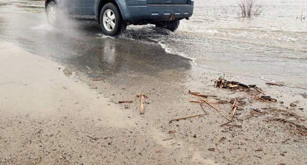 istock Car Driving Through Shallow Flooded Area 1361363885