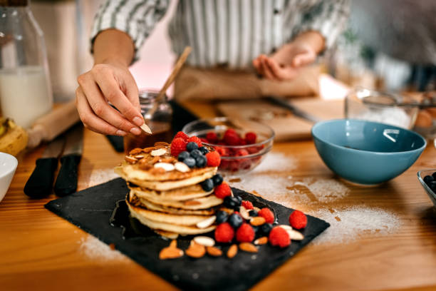 istock Young women preparing pancakes for breakfast 1361365012