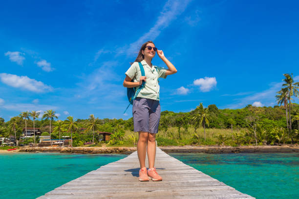 istock Woman at Wooden jetty (bridge) 1361365513