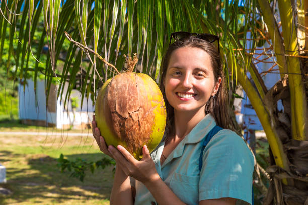 istock Woman holds coconut 1361366571