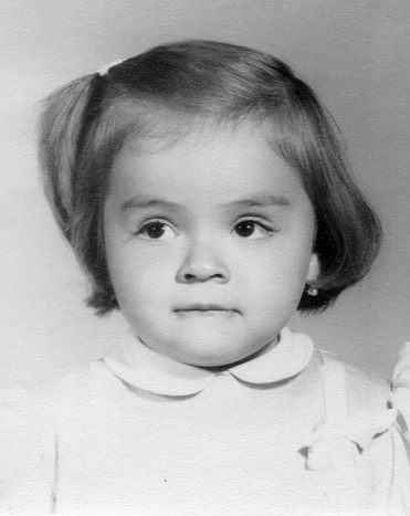 Image taken in the 60s hispanic Little girl looking away portrait