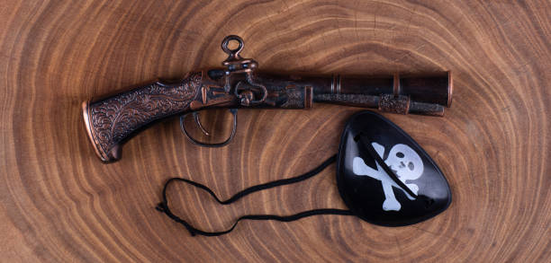 istock antique pirate pistol on wooden background 1361370281
