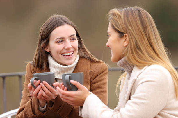 istock Two happy friends drinking and talking in winter 1361371437