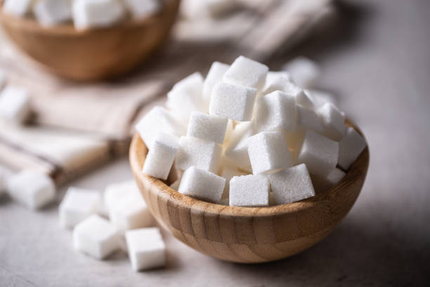 istock White sugar cubes in a wooden bowl on the table. 1361373998