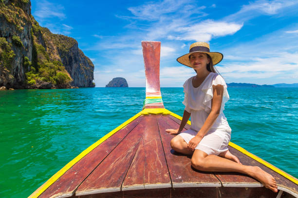 istock Woman on boat in Thailand 1361374268