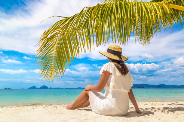 istock Woman under palm leaf 1361375479