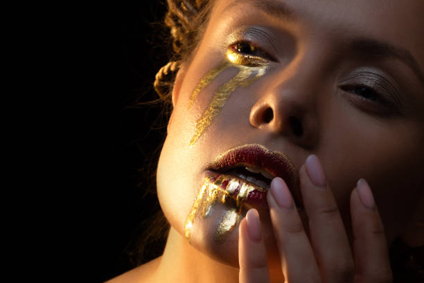 istock Glamorous tears, face art and creative makeup, gold on the face 1361375755
