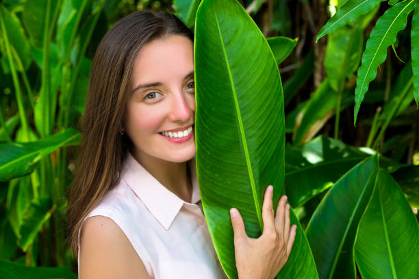istock Woman and large tropical leaves 1361381910