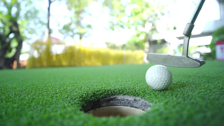 Man making a putt in miniature golf