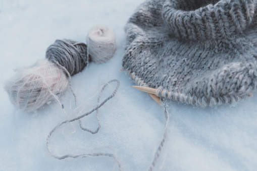 Fashionable wool and knit-work sweater project in snow