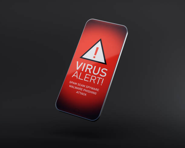 Smart phone with virus alert Smart phone on dark background showing red virus alert symbol and text phone spam photos stock pictures, royalty-free photos & images