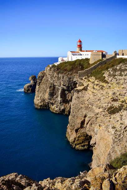 istock Lighthouse on Cabo de Sao Vicente cliffs, rocky Algarve coastline 1361389329