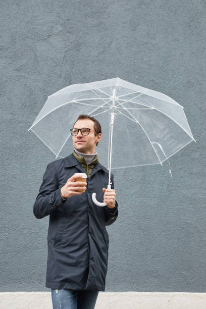 istock Man Drinking Coffee On Rainy Day 1361389640