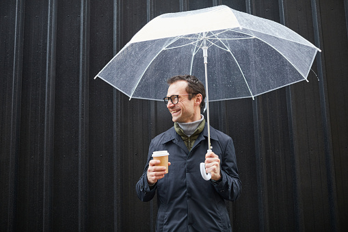 Man holding umbrella on a rainy day