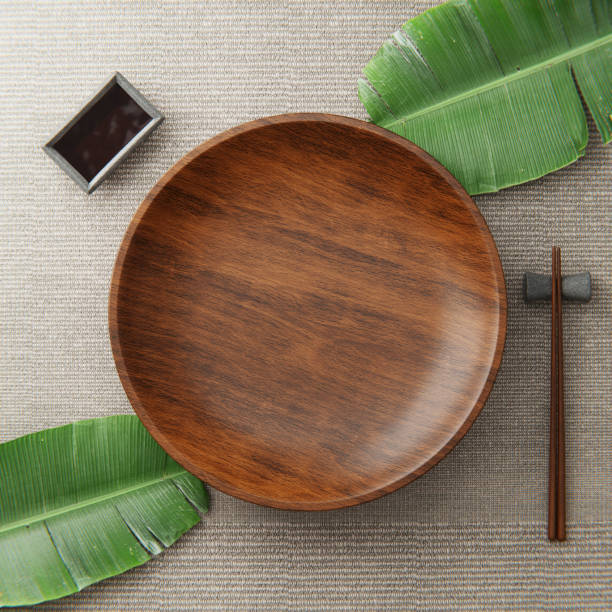 istock Wooden kitchen board. On a grey background with leaves. Top view. Free space for text. 3d illustration. 1361391114