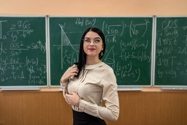 istock teacher explain completing mathematical equations on chalkboard in classroom 1361391217