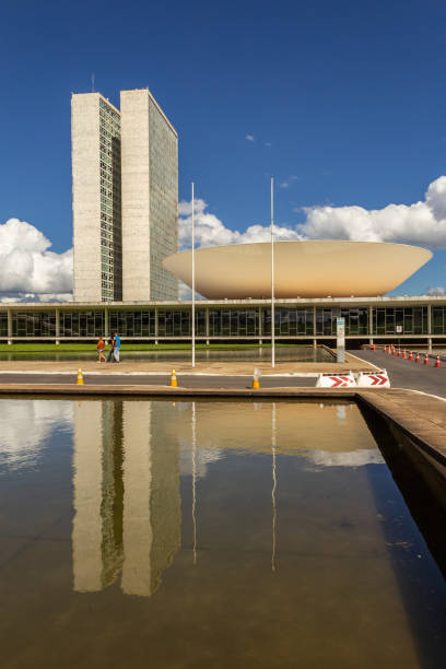 Nacional Congress Palace. Brasilia, Federal District, Brazil – December 25, 2021: National Congress Palace with reflection in the water mirror, on a clear day with cloudy sky. The National Congress Palace is a work of architect Oscar Niemeyer. 1814 stock pictures, royalty-free photos & images