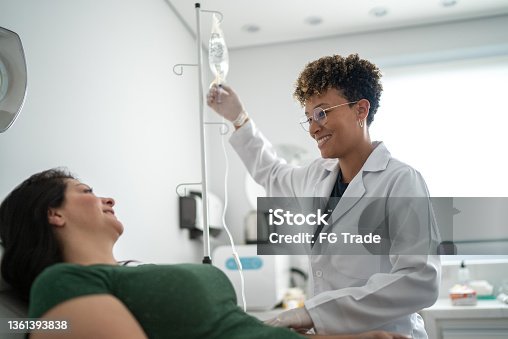 istock Doctor talking with a patient and taking IV drip at a medical clinic 1361393838