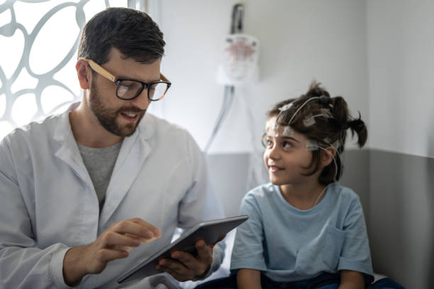 istock Doctor talking to a boy before polysomnography (sleep study) 1361393950