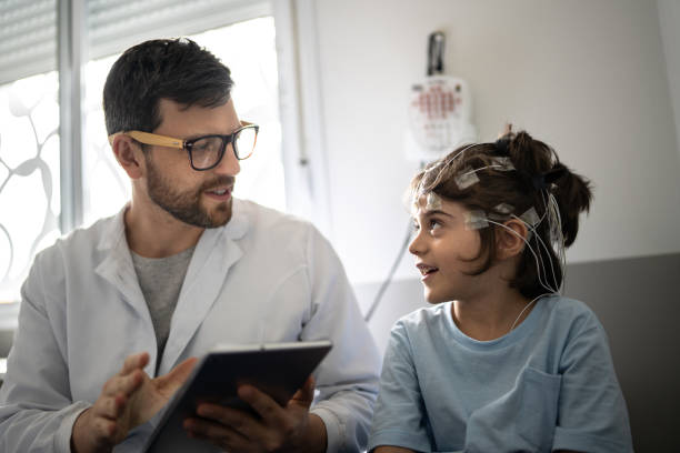 istock Doctor talking to a boy before polysomnography (sleep study) 1361393954