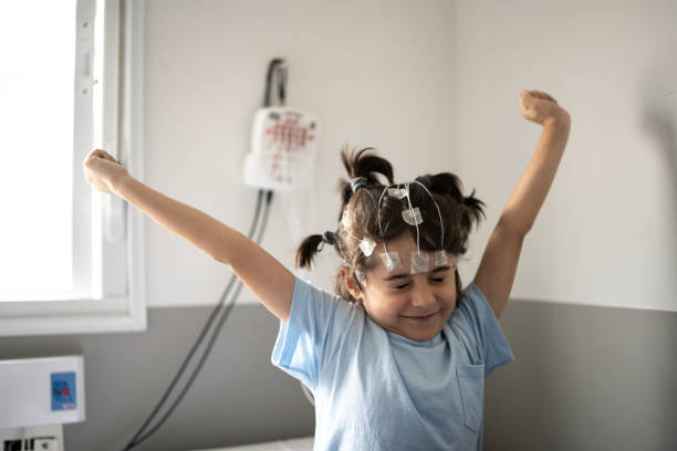Boy stretching in a bed at a medical clinic doing polysomnography (sleep study)