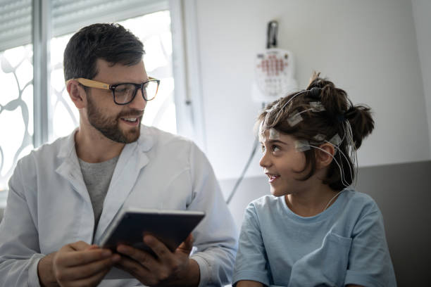 istock Doctor talking to a boy before polysomnography (sleep study) 1361393967