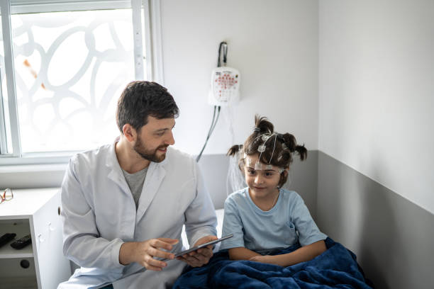istock Doctor talking to a boy before polysomnography (sleep study) 1361393969