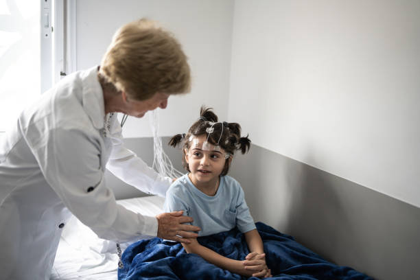 istock Doctor talking to a boy before polysomnography (sleep study) 1361394018