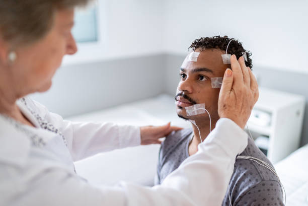 istock Doctor preparing a patient for polysomnography (sleep study) 1361394233