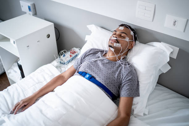 istock Patient sleeping in a medical clinic doing polysomnography (sleep study) 1361394278
