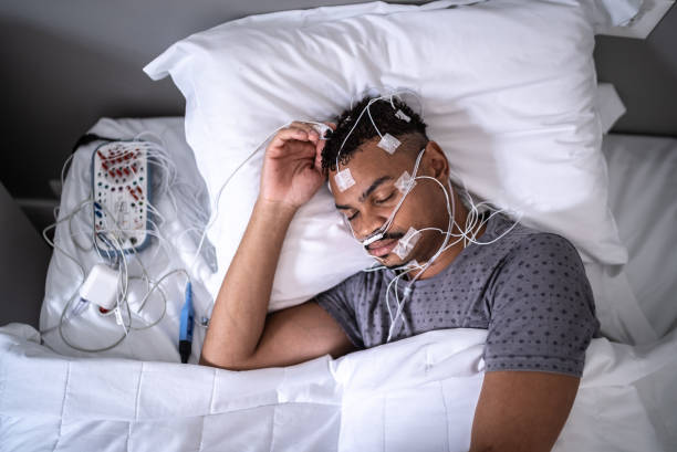 istock Patient sleeping in a medical clinic doing polysomnography (sleep study) 1361394284
