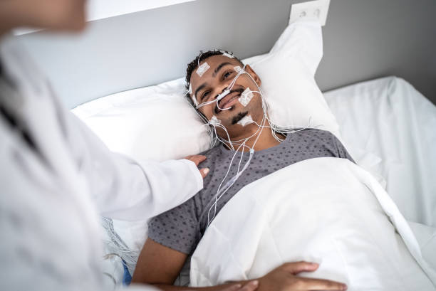 istock Doctor checking on a patient in a bed doing polysomnography (sleep study) 1361394301