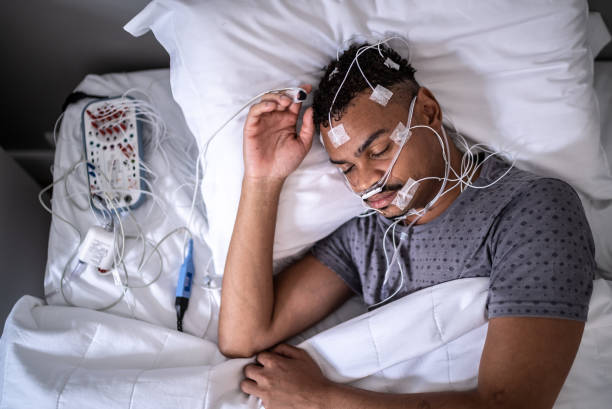 istock Patient sleeping in a medical clinic doing polysomnography (sleep study) 1361394317