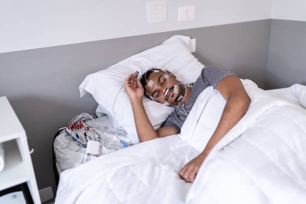 istock Patient sleeping in a medical clinic doing polysomnography (sleep study) 1361394357