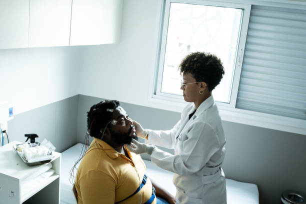 istock Doctor preparing patient's for polysomnography (sleep study) 1361394470